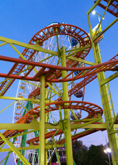 Roller Coaster in the city amusement park at evening.