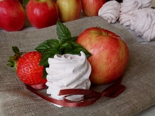 Beautiful zephyr with apple, strawberry and mint tied with string on burlap