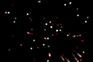 Fototapeta na wymiar Colorful blurred lights on black. Firework.