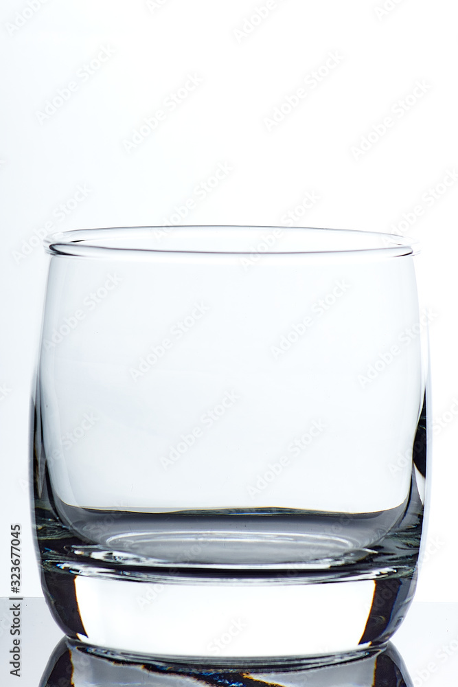 Wall mural set of glass empty glasses and goblets on a gray-white background