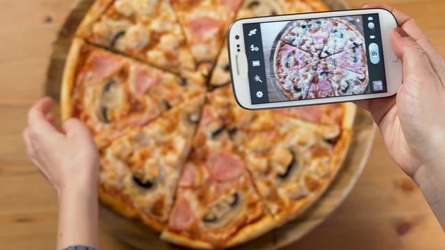 A Woman's Hands Take Photos Of Food From Her Smartphone: Delicious Italian Pizza. Close Up.