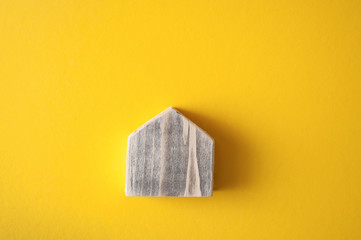 Wooden house on the bright yellow background