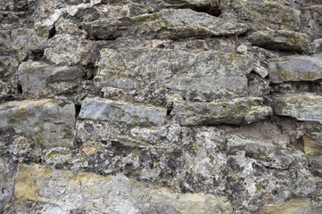 Historic stones. Rough natural masonry with wide seams on a medieval watchtower. Light rough stone.