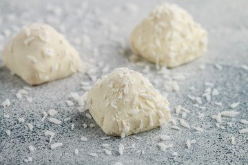 Homemade white chocolate candies with coconut. Delicious healthy dessert. Selective focus