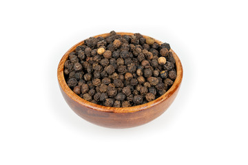 A small wooden bowl filled with whole black peppercorns isolated in front of a white background