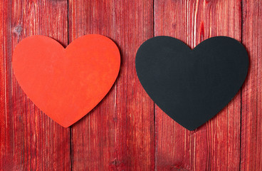 Red and black heart on wooden background. Love valentines day