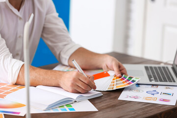 Professional interior designer at workplace in office, closeup