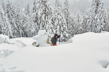 woman is engaged in trekking in the winter mountains