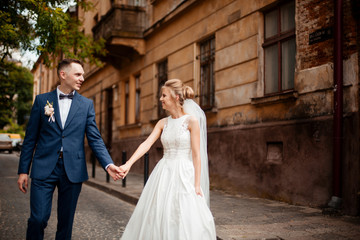 A loving couple of newlyweds walks in the city. Husband and wife on a walk