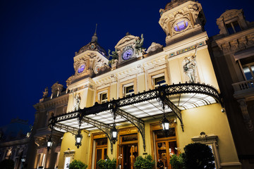 Close-up view of the facade of the Grand Casino in Monte Carlo. Principality of Monaco. Details with clock on top of the 19th century baroque style palace of the Monte Carlo Casino. Night sky.