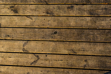 Fototapeta premium Wooden surface floor as texture grungy scratchy wood close up as retro vintage background toned in warm colors
