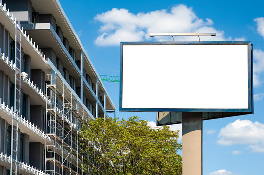 Blank white billboard mockup in front of the modern building under construction