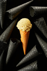 Single colored ice cream in a cone amongst grey