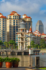 observation tower a stylized lighthouse on a river channel in Singapore against the background of a city block