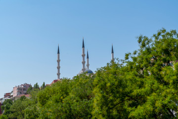 Obraz premium Kocatepe Mosque behind green trees, Ankara, Turkey
