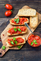 Italian bruschetta with tomatoes, olive oil, green parsley and pink pepper. typical Italian antipasti starter in a restaurant in Italy Rome Milan. tomato bruschetta recipe, selective focus