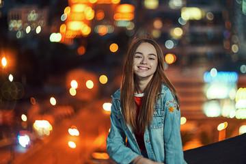 Lovely teen girl smiling on cityscape background