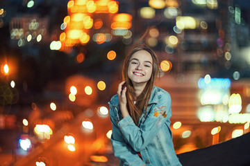 Lovely teen girl smiling on cityscape background