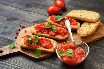 Italian bruschetta with tomatoes, olive oil, green parsley and pink pepper. typical Italian antipasti starter in a restaurant in Italy Rome Milan. tomato bruschetta recipe, selective focus
