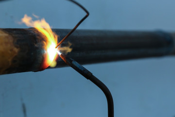  welding metal pipe by gas burner close up