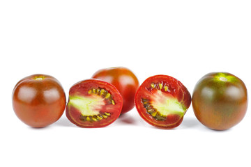 Whole and cut on half brown color tomatoes isolated on white background.