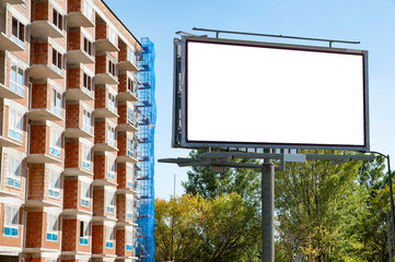 Blank white billboard for advertisement in front of the modern apartment building