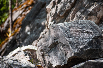 Large marble rough stones on the background cliff