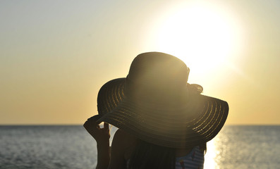 Little girl plays on summer sunset beach