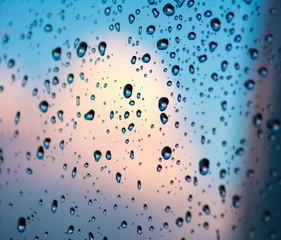 drops of water on a glass blue sky clouds
