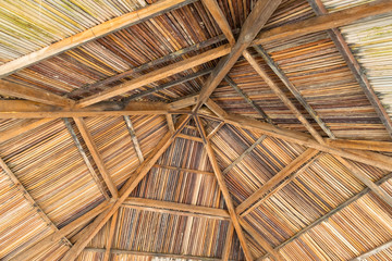 Mounting a straw umbrella from below with wooden beams