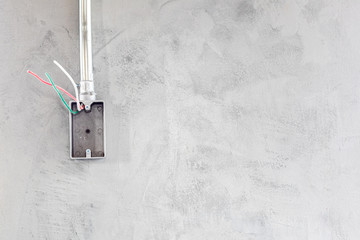 Electrical socket boxes with wires on cement wall in a wall under construction unfinished frame, Unfinished electrical plug box on the cement wall - Interior concept.