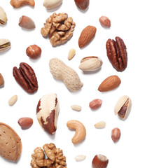 Different delicious nuts on white background, flat lay. Space for text