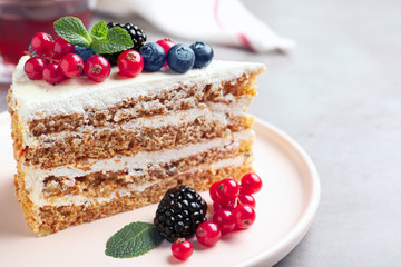 Tasty cake with berries on grey table, closeup