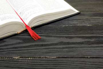 Composition with vintage old hardback books, diary, fanned pages on wooden deck table and red background. Books stacking. Back to school. Copy Space. Education background.