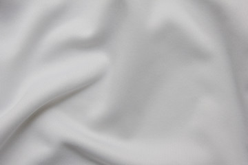 Linen white fabric texture of crumpled bed sheets. Light bedding cloth background, cotton wrinkled material pattern, close up top view of used bedsheet 