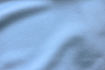 Fototapeta premium Silky blue sheet material, empty fabric texture wrinkled pattern. Crumpled cloth surface, bluish white background mockup, close up top view 