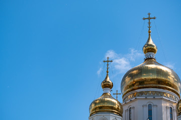 Fototapeta na wymiar Khabarovsk, Russia - Jun 15, 2019: Spaso-Preobrazhensky Cathedral in Khabarovsk on the background of blue cloudy sky.