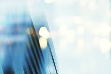 Abstract business modern city urban futuristic architecture background, motion blur, reflection in glass of high rise skyscraper facade, toned blue picture with bokeh. Real estate concept