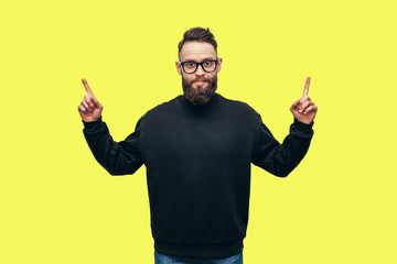 Portrait of handsome hipster guy with beard wearing black blank hoody or sweatshirt and black cap...