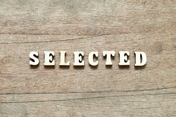 Fototapeta premium Letter block in word selected on wood background