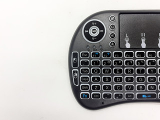 Modern Artistic Black TV Remote with QWERTY Keypad and Game Tools in White Isolated Background