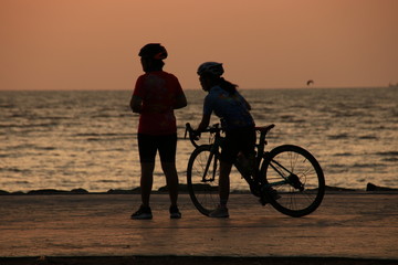 Obraz na płótnie Canvas The silhouette of the cyclist at sunrise