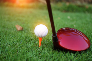 Golf ball and golf club in beautiful golf course.