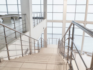 Stairway with chrome guard rails at car showroom