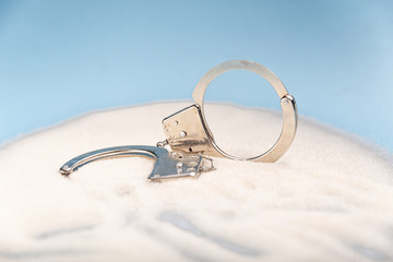 Sugar is dangerous. Handcuffs on the table. Sweet dependence