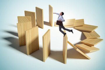 Businessman in domino effect concept