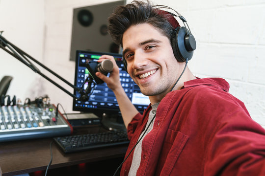 Image Of Young Happy Dj Man Wearing Headphones Working At Radio Station