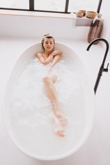 Beautiful woman relaxing in the bathtube.