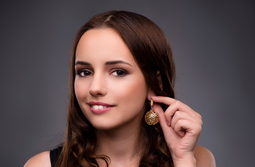 Obraz premium Young woman showing her new earrings