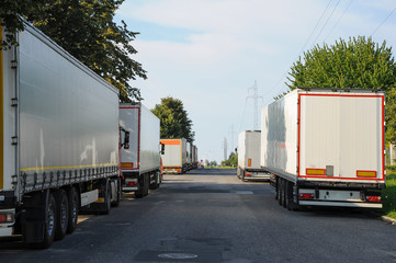 A lot of trucks parked along the road